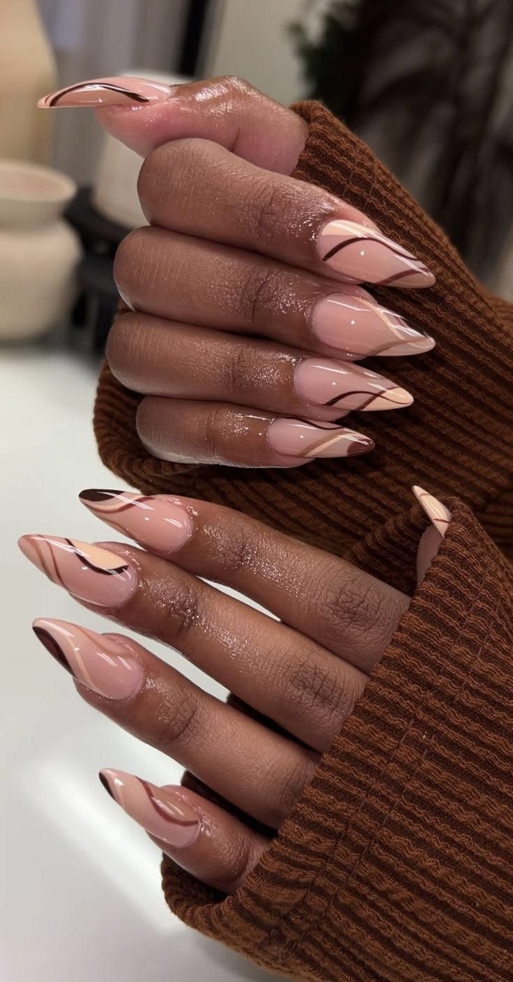 Nude almond nails with swirl detail